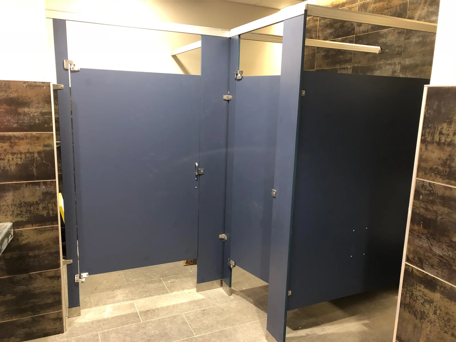 Warehouse restroom toilet partition installation.